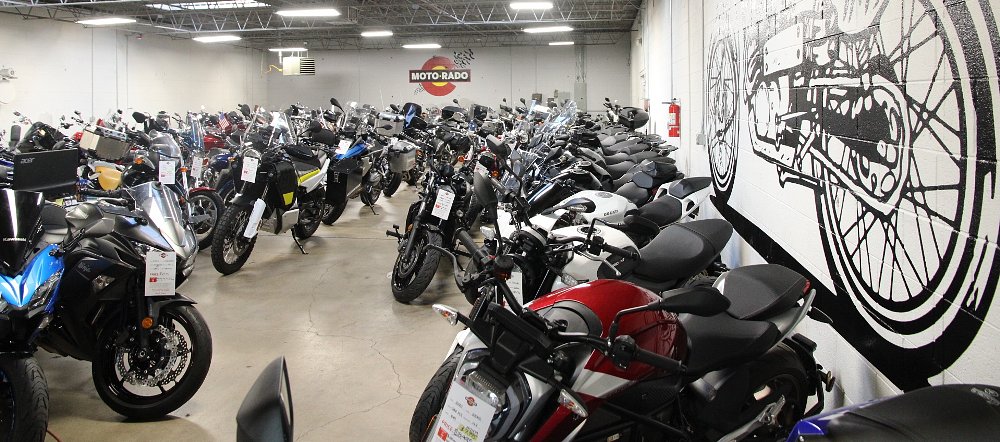 view of the Motorado showroom with rows of used motorcycles for sale