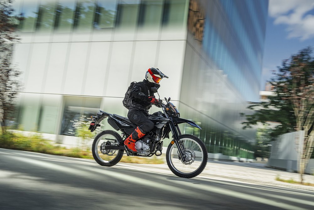rider on a WR125R dual-sport motorcycle in the city