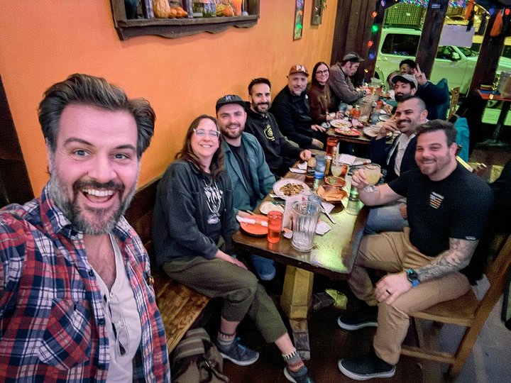 Spurgeon and a group of co-workers at a dinner in a restaurant