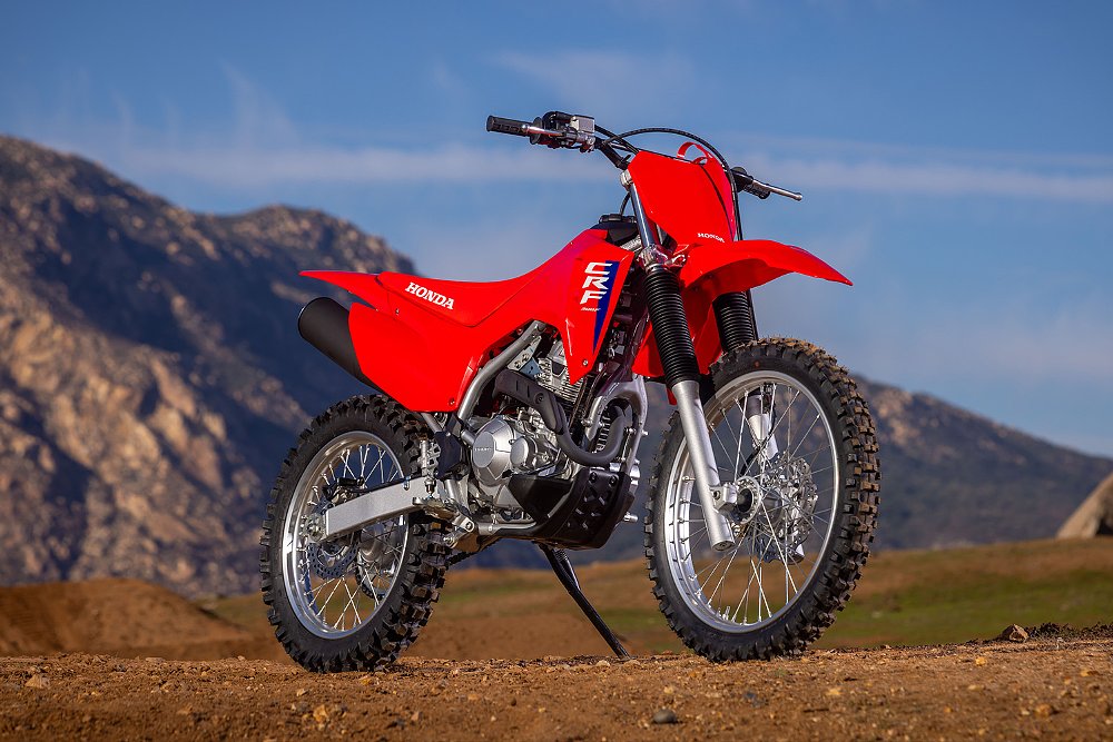 The CRF300F pictured with a mountains in the background.