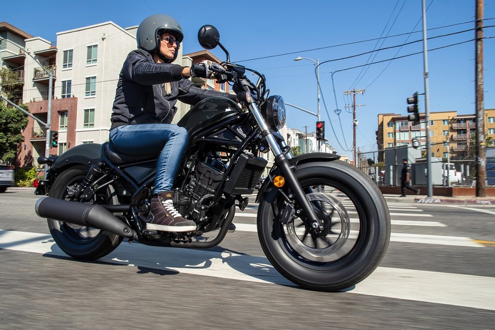 a young rider on a Honda Rebel 300 in the city