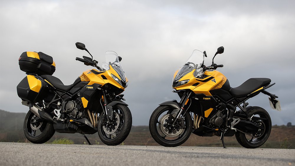 two Triumph Tiger Sport 800s in yellow, one with a full set of matching luggage