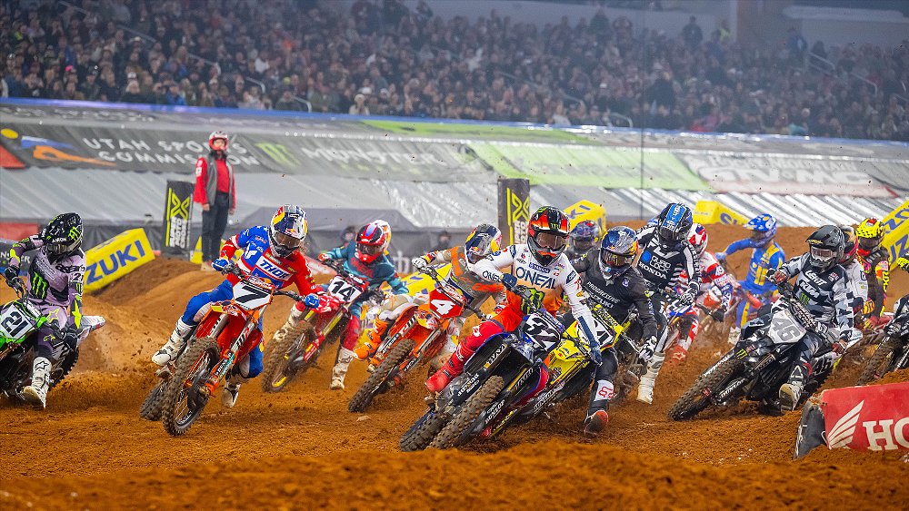 A pack of Supercross riders battle for the hole shot at the Utah round.
