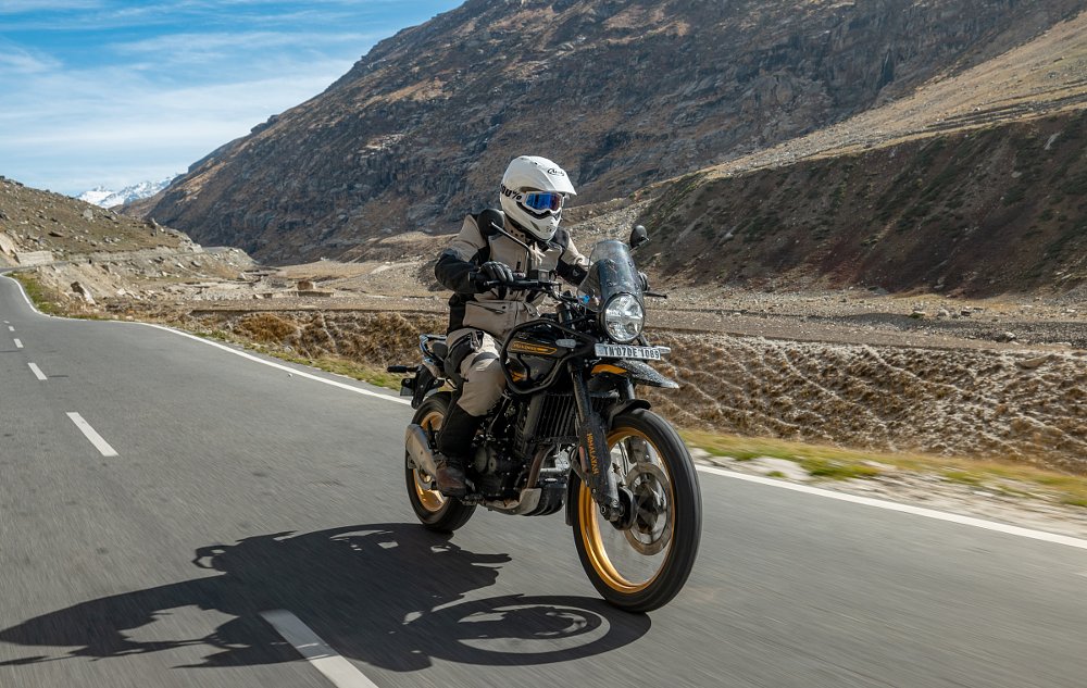 Rider on a Royal Enfield Himalayan on a remote road in the mountains of India