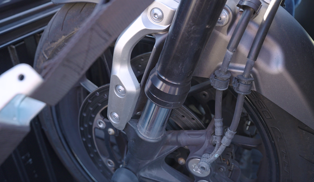 Fork compression is key to motorcycle stability when towing. 