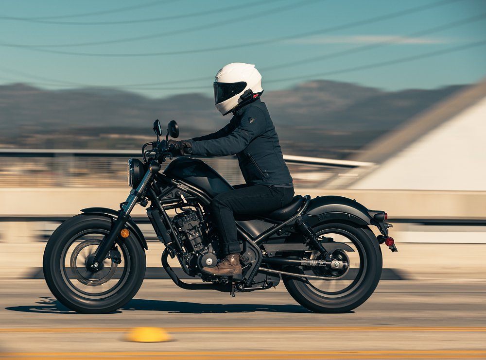 side view of rider on the Rebel on a highway