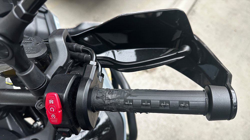 A close-up of the Ibex 450's throttle tube stripped of its rubber grip.