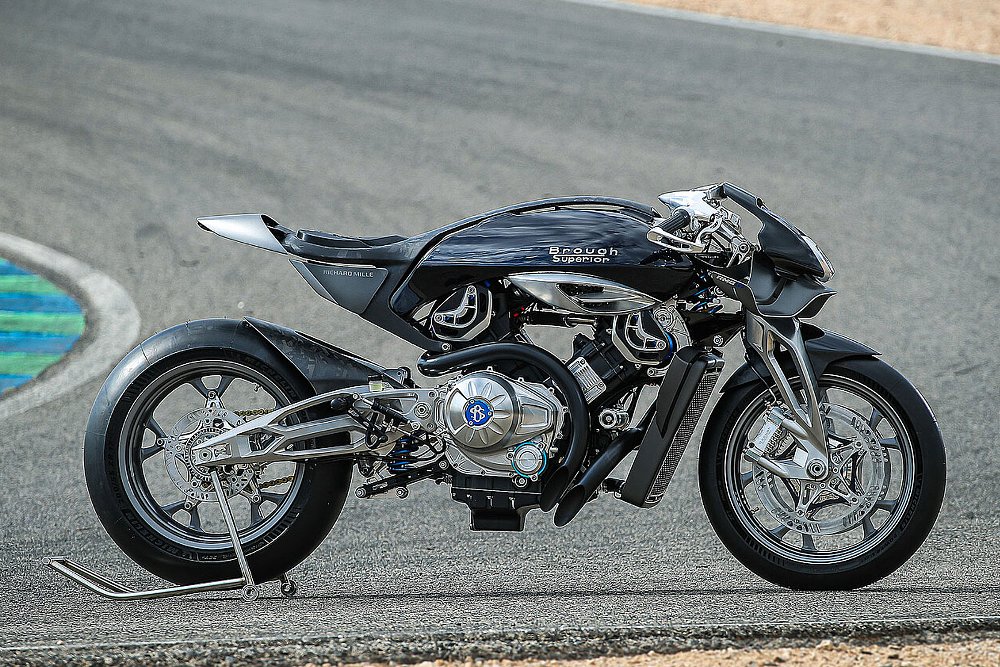 the sleek black cafe racer custom parked on a race track