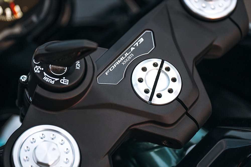 A close-up of the Formula 73's serialized top-clamp badge.