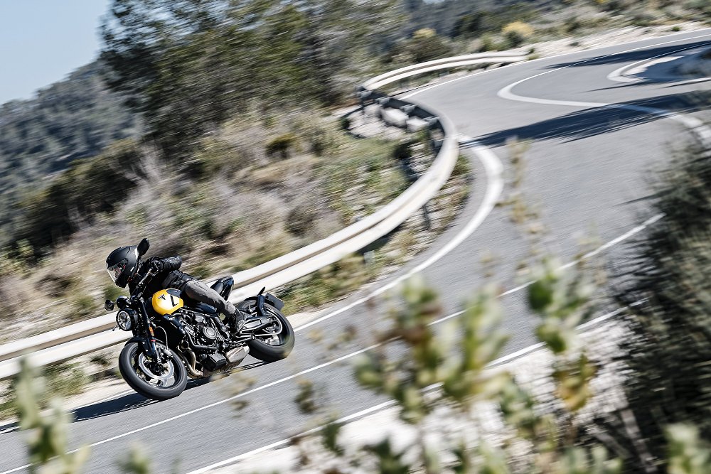 view of a rider on a curving road in the hills in Spain