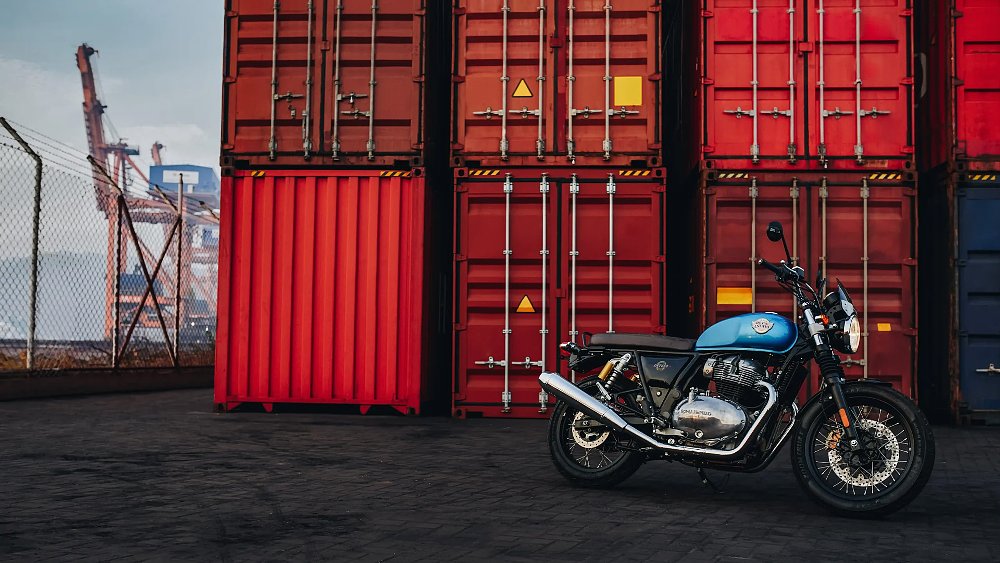 A Royal Enfield Interceptor 650 staged in a shipping yard.
