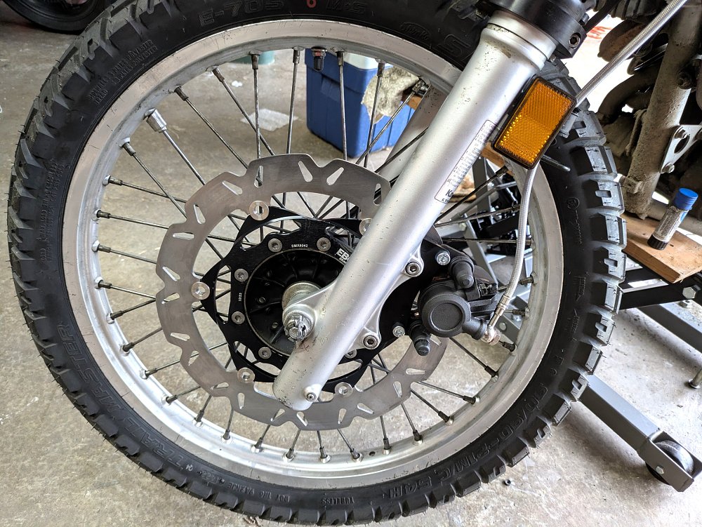close view of the front wheel with a new, oversized brake rotor