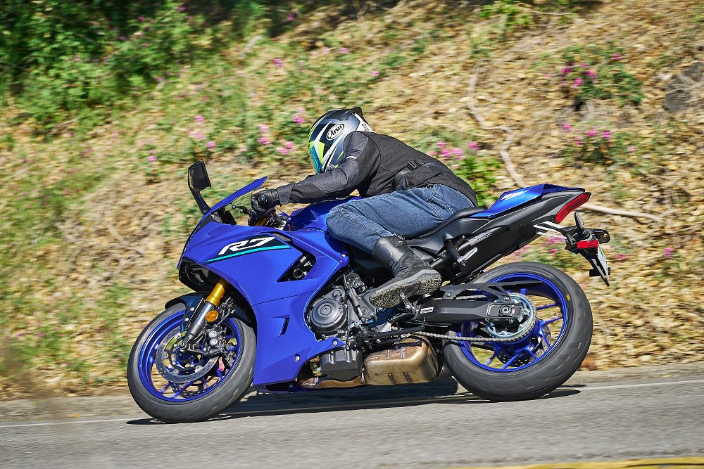 rider on the blue R7 on a curvy road, side view