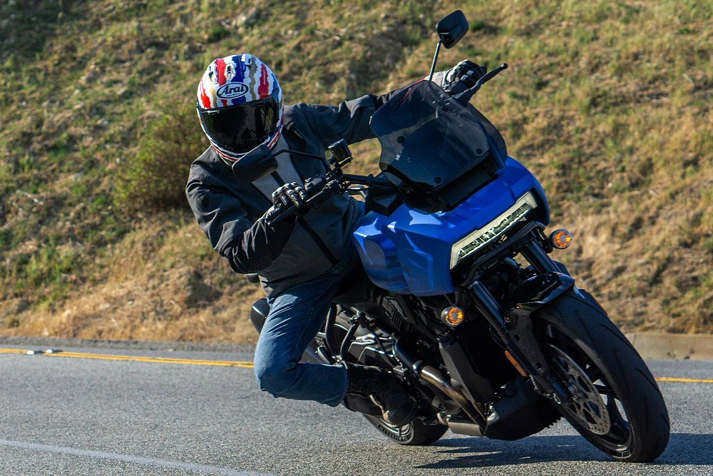 Dustin hangs off the side of the Pan America ST while riding through a corner.