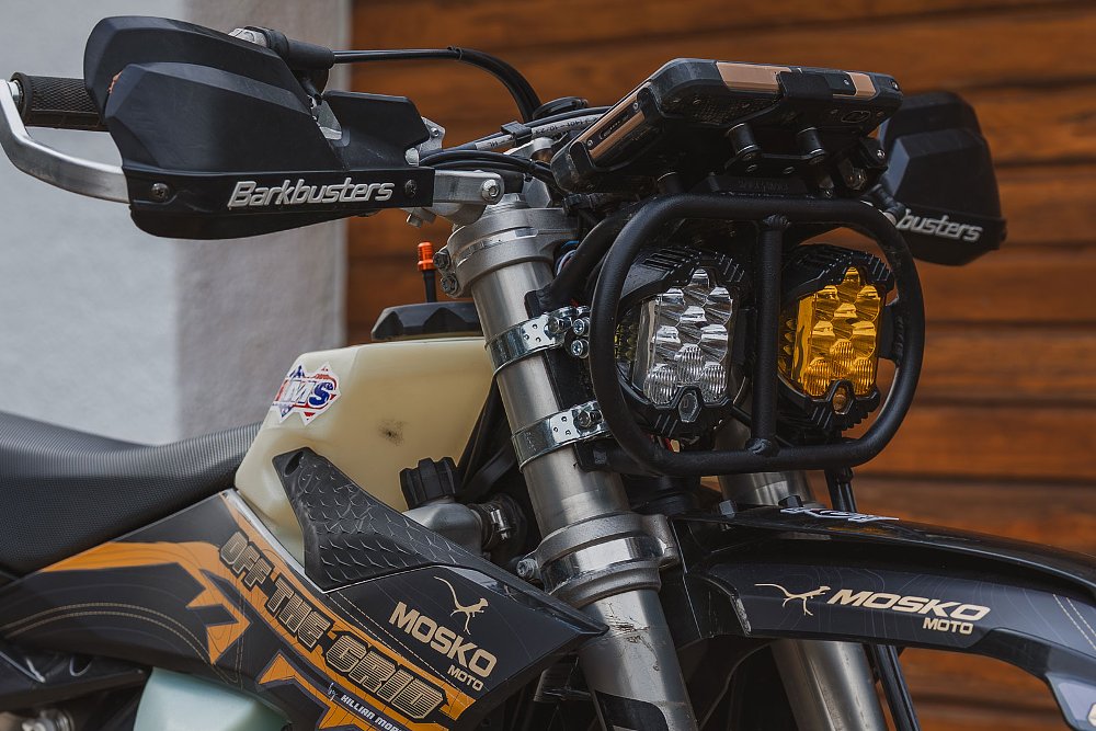 front view of the motorcycle showing the dual round headlights, one clear, one tinted yellow