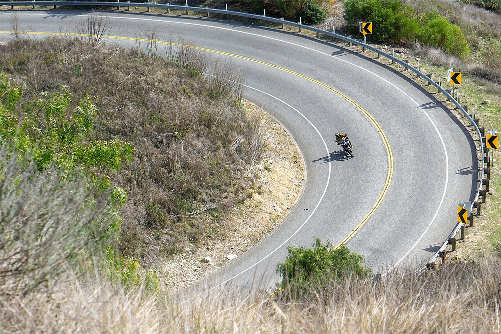 Dustin rides the Ibex 450 through a long, sweeping curve.