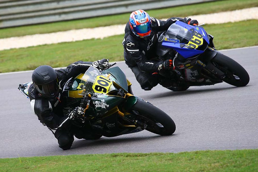 Road racers battle for position on the racetrack. 