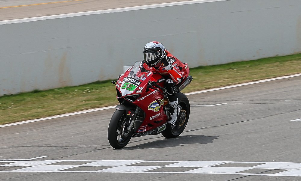 Darryn Binder crossing the finish line to win the race