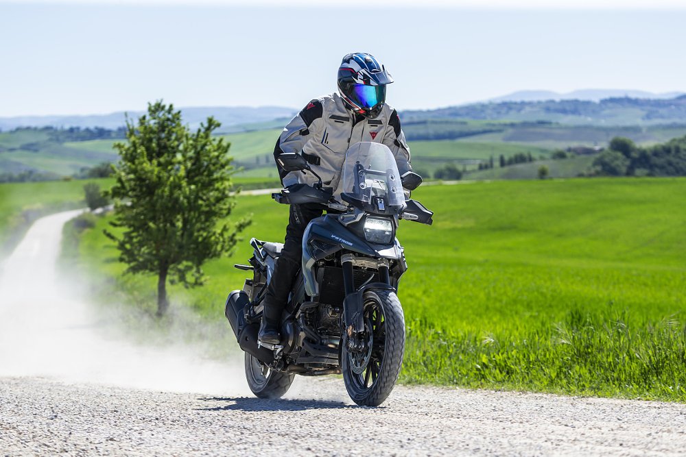 rider on a Suzuki V-Strom on an unpaved road in Tuscany