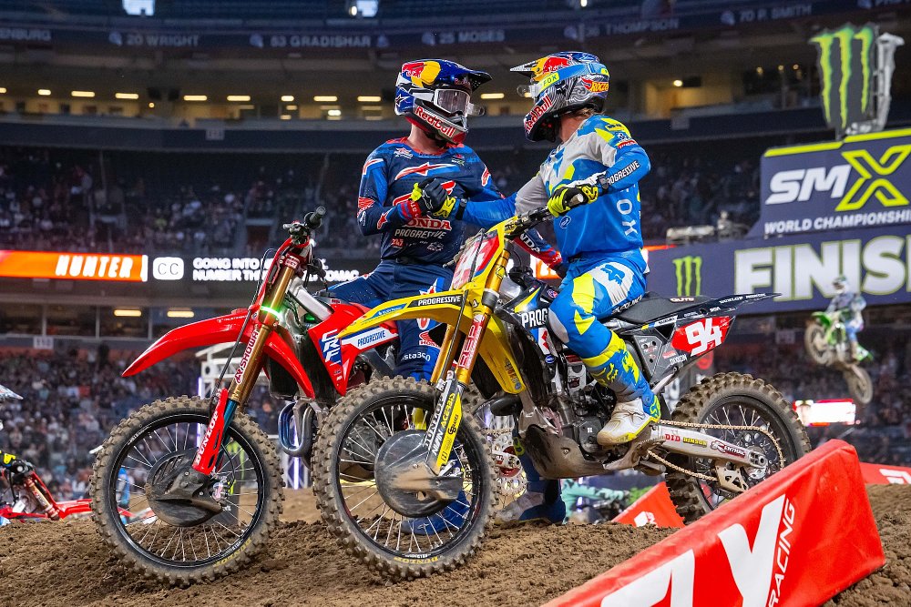 Lawrence and Roczen shake hands while sitting on their race bikes after the end of the race in Denver