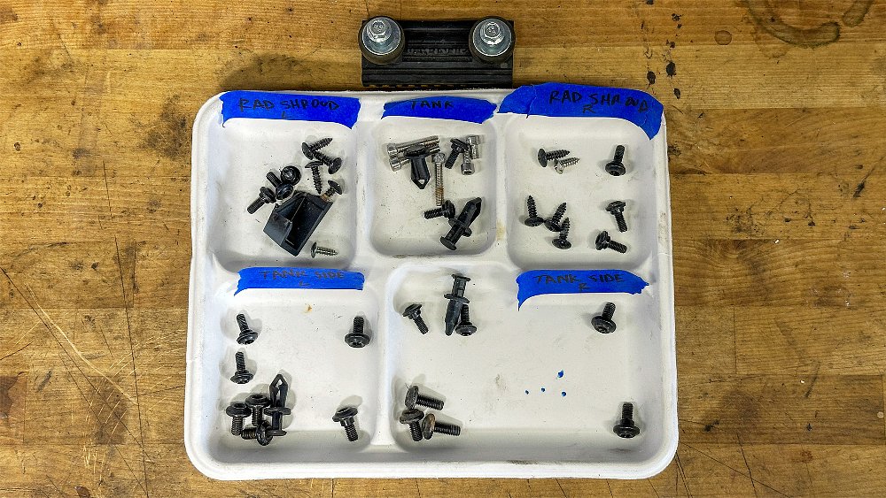 A paper trail filled with Ibex 450 screws, bolts, and fasteners.