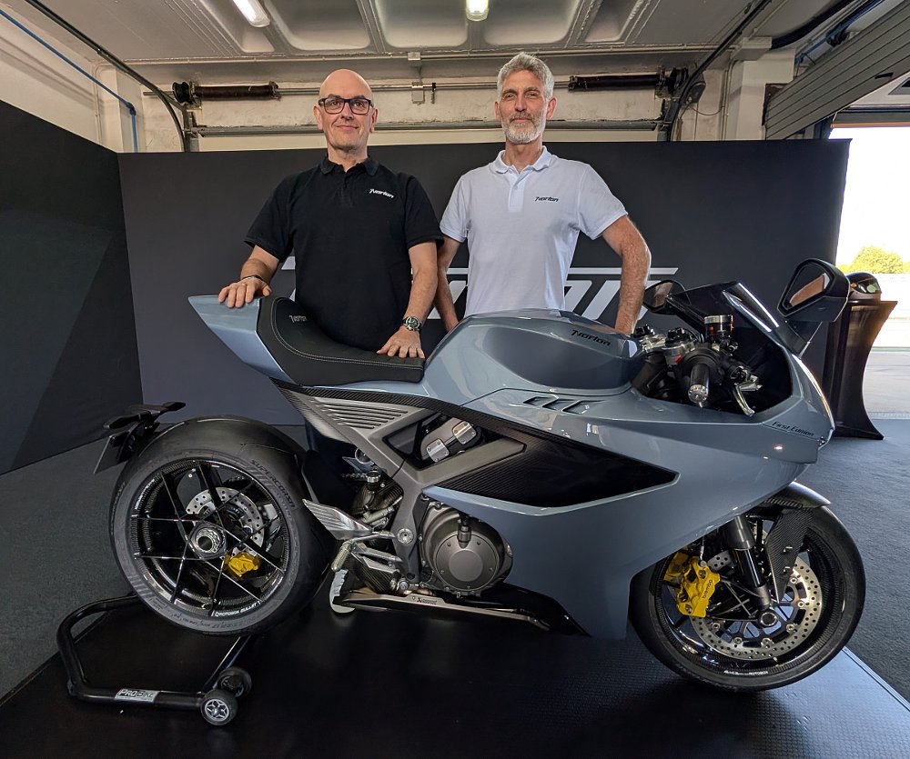 Skinner and Gillen posing in the trackside garage with a silver Manx R