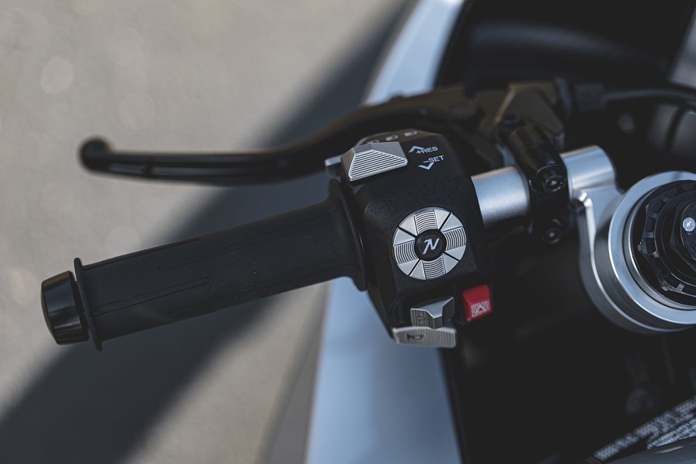 close view of left switchgear on the Manx R showing silver-colored metal buttons