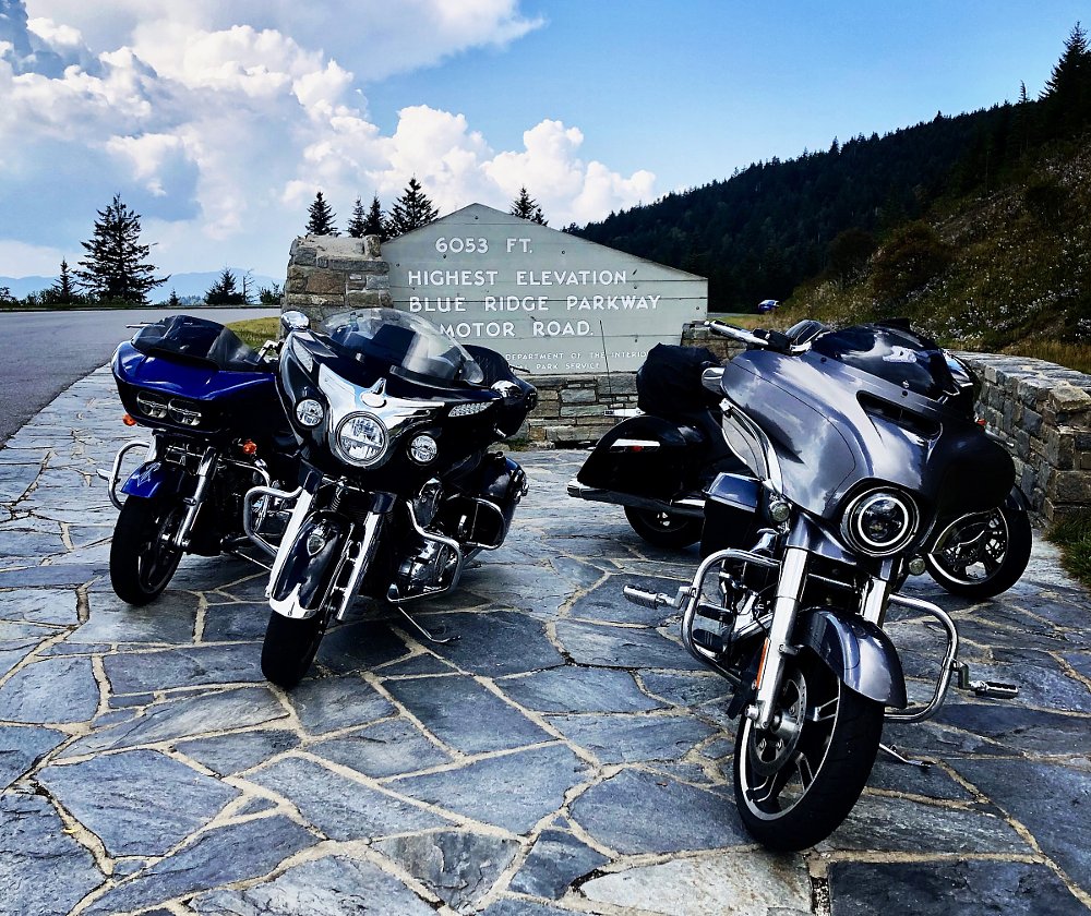 motorcycles parked at the sign marking the highest elevation on the Blue Ridge Parkway