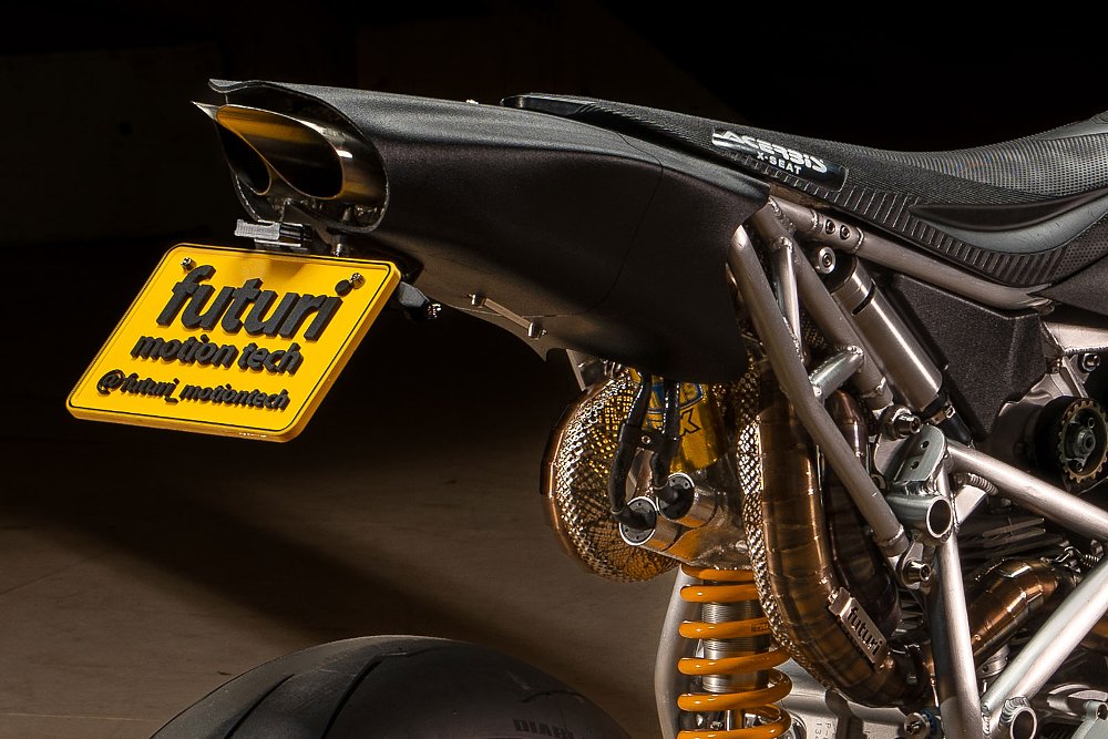 close view of curving exhaust pipes exiting under tail