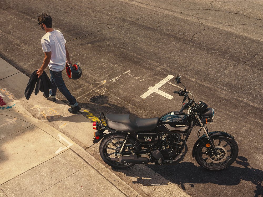 A rider walks away from a parked W175 LTD.