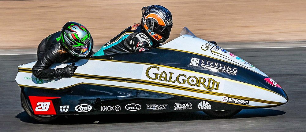 Maria Costello and her sidecar passenger motor down a stretch of the Snaefell Mountain Course.