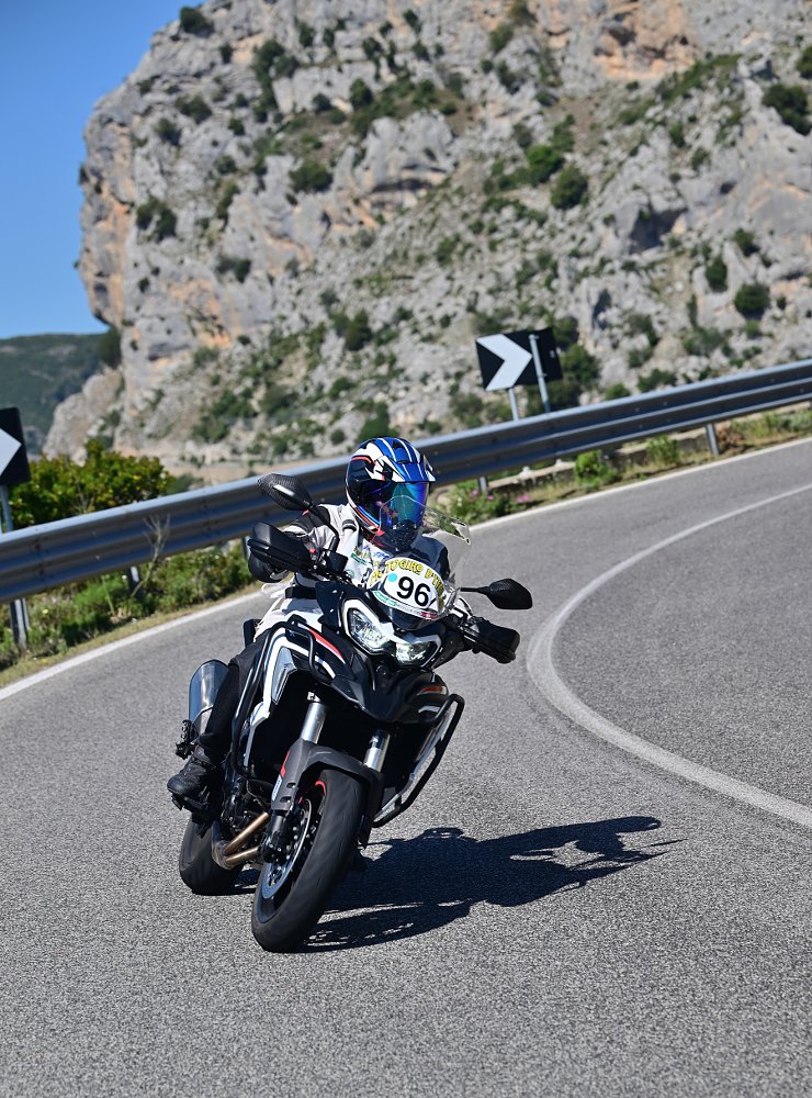 riding through a curve on a road in Sardinia