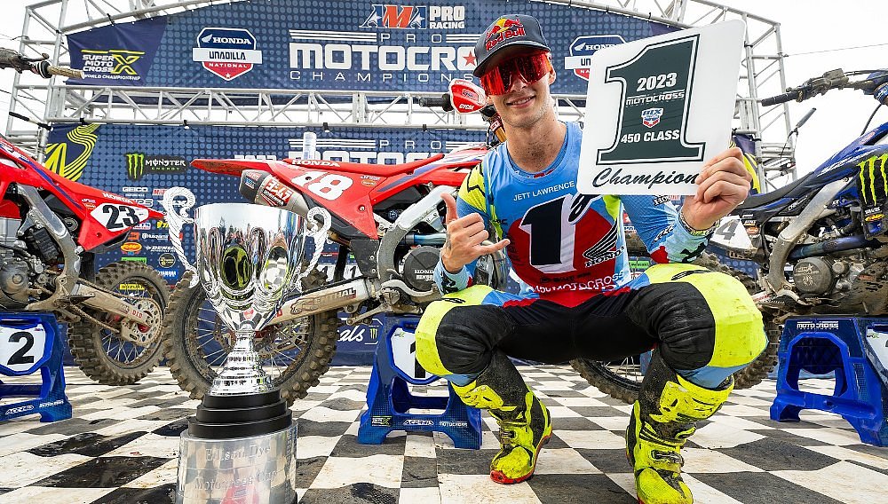 Jett Lawrence smiles and holds the #1 plate after clinching the 2023 AMA Pro Motocross championship