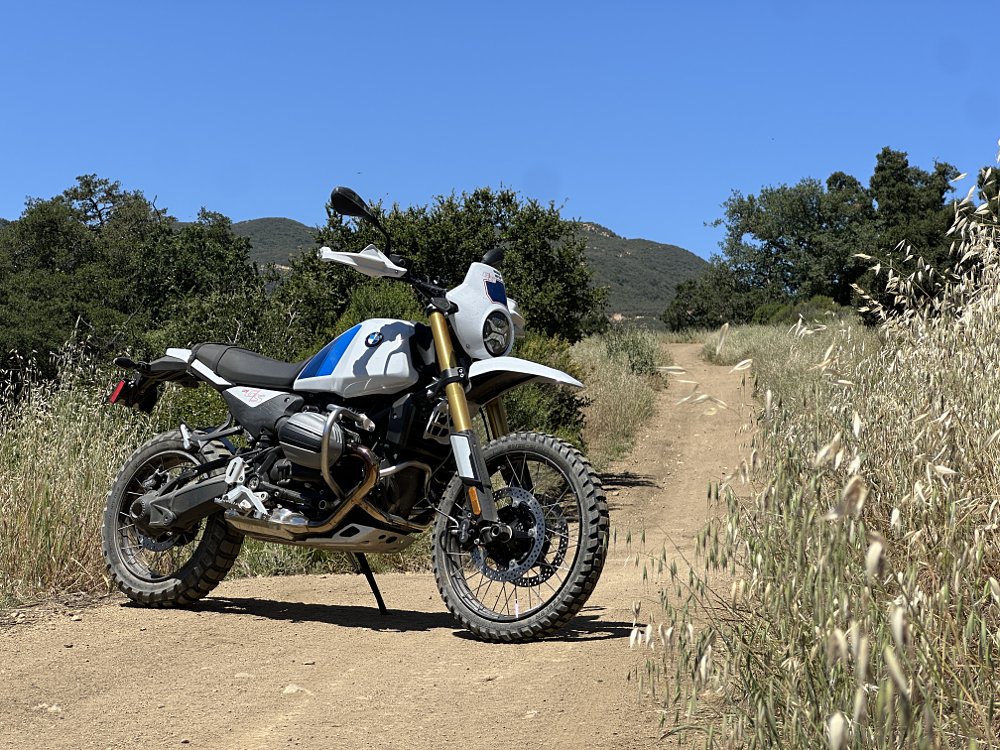 BMW's R 12 G/S parked on a grass-lined dirt road on a sunny day.