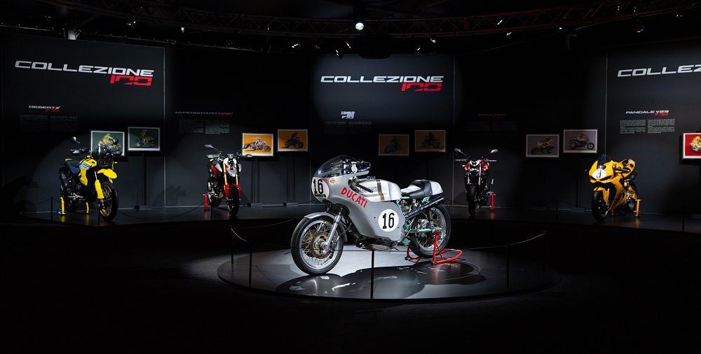 art gallery style display of limited edition motorcycles under spotlights