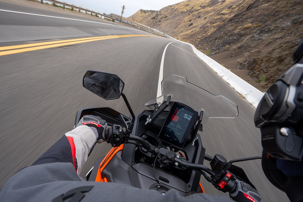 2027 KTM 1390 Super Adventure S EVO onboard image over the rider's shoulder, showing a view of the 8-inch TFT screen.