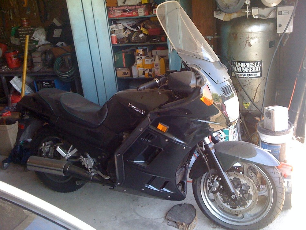 the green Kawasaki Concours, covered in dusty, in a crowded garage