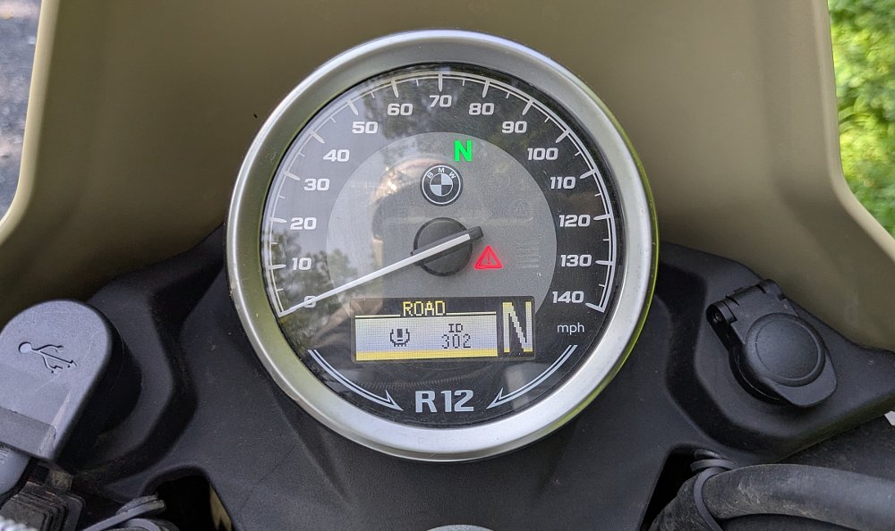 close view of the round dial display with a tire pressure warning showing in the LCD window