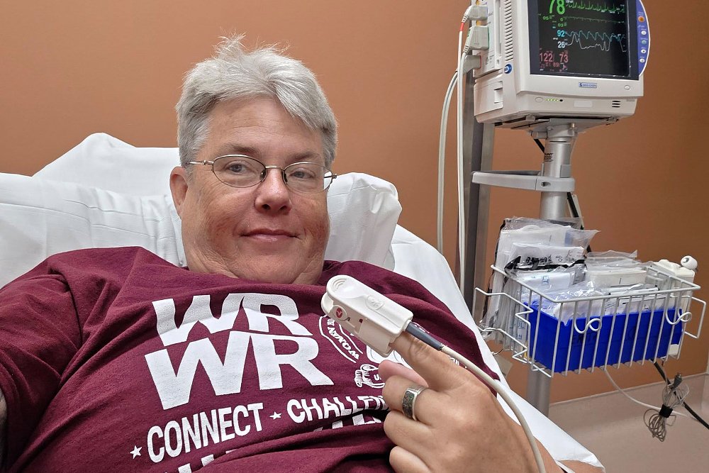 Liza takes a selfie in a hospital bed.