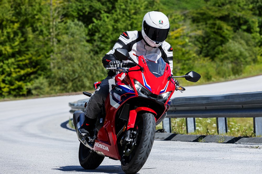 rider on a curve on the red CBR500R
