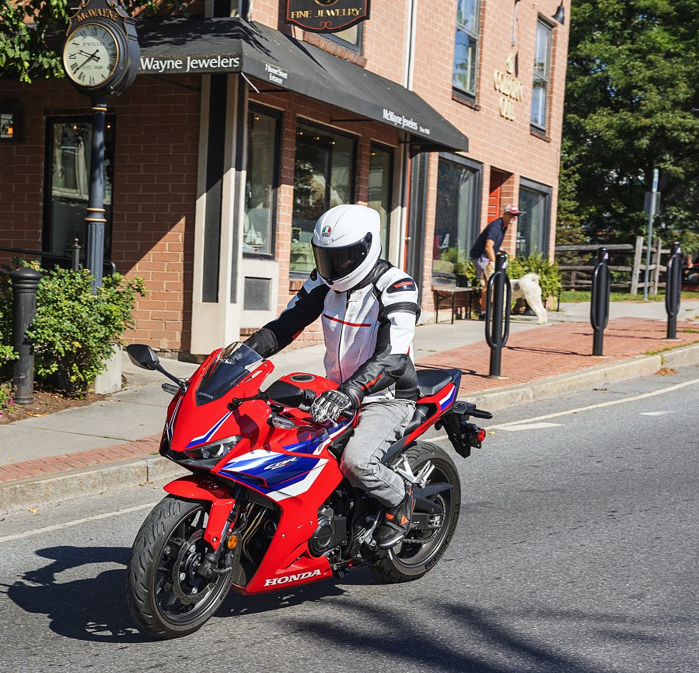 riding the CBR500R in town past a storefront