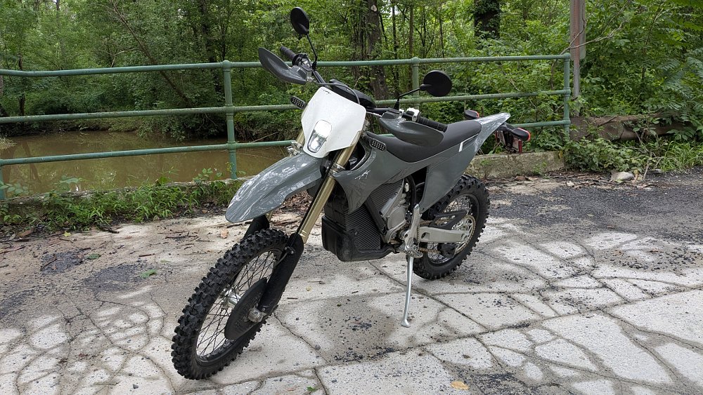gray Stark VARG EX on a bridge above a muddy creek in the country