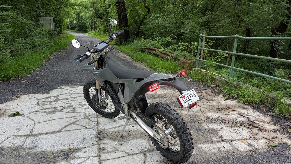 gray Stark VARG EX on a dirt road with a license plate on it
