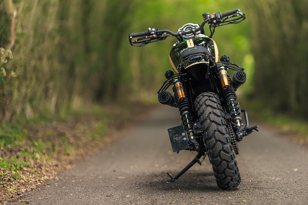 rear view of the motorcycle on a trail showing the knobby rear tire