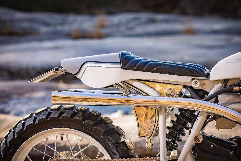 close view of the seat and tail section with a triangular shiny aluminum tank underneath the seat