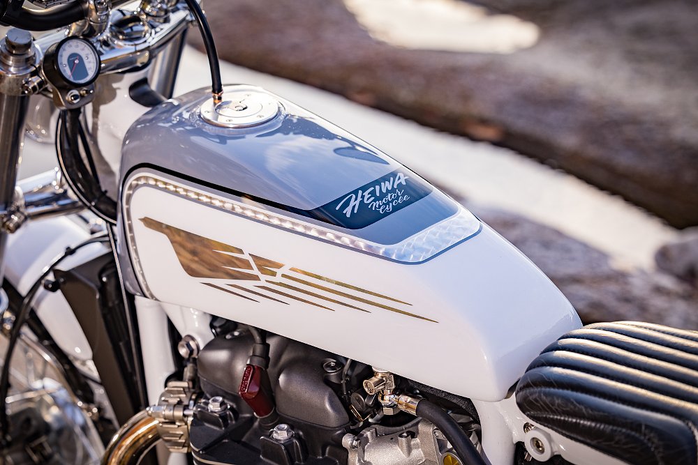 close view of the front fuel tank with white and silver paint and intricate pinstriping
