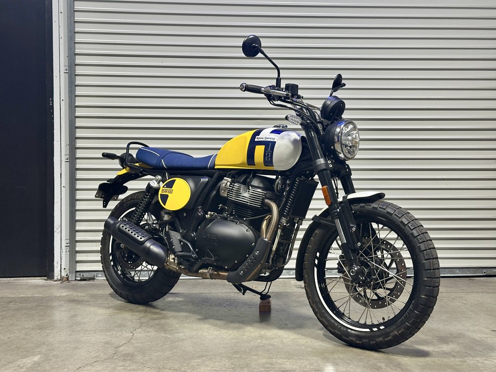 2026 Royal Enfield INT Bear 650 parked in front of a garage door.