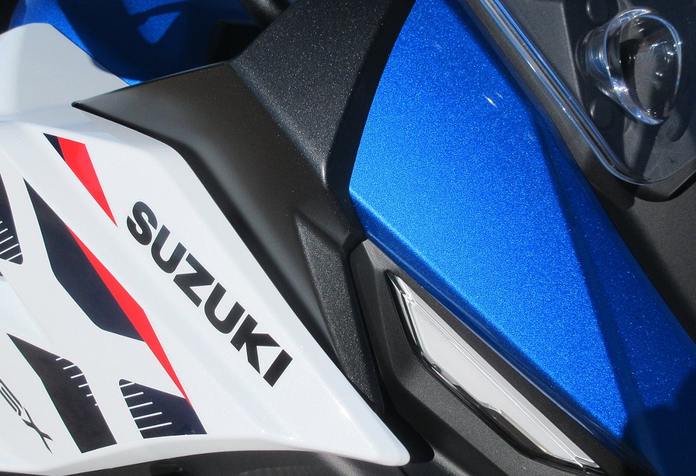 close view of the blue and white paint in the sunlight, showing a metallic sparkle