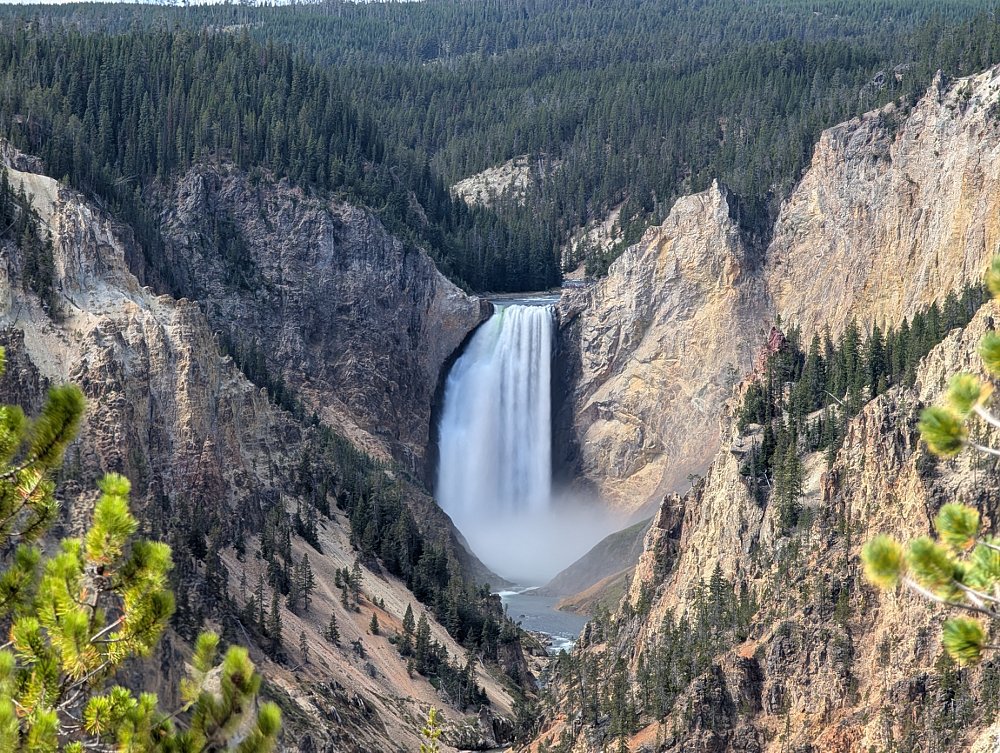 a beautiful waterfall in a V-shaped cut in distant mountains