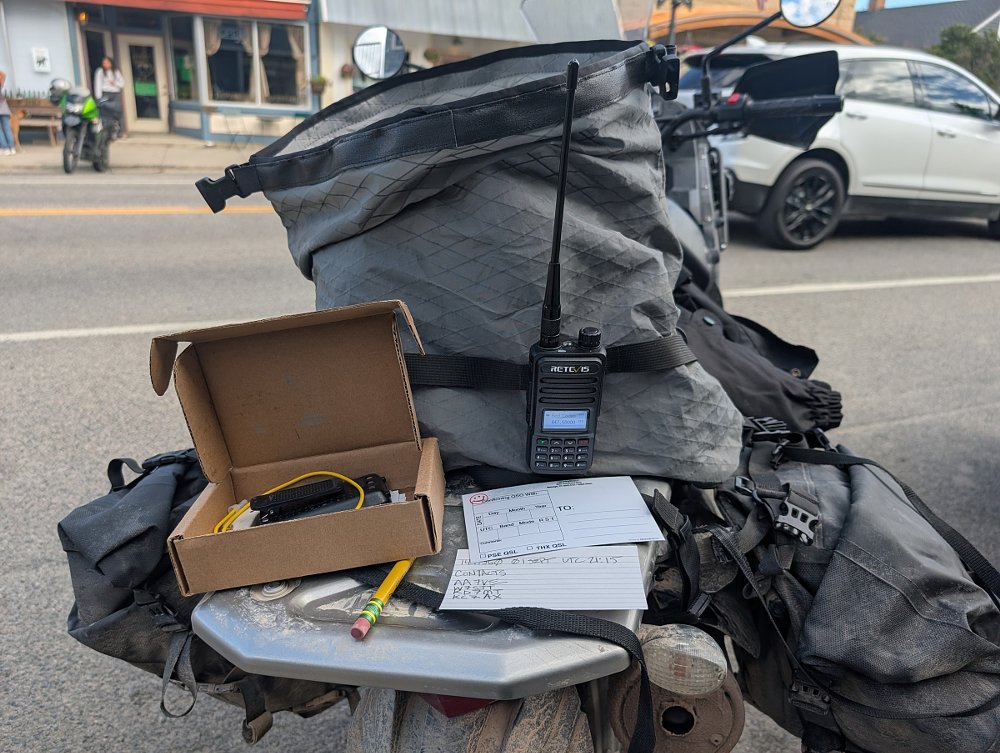 portable radio gear on the rear rack of the KLR650